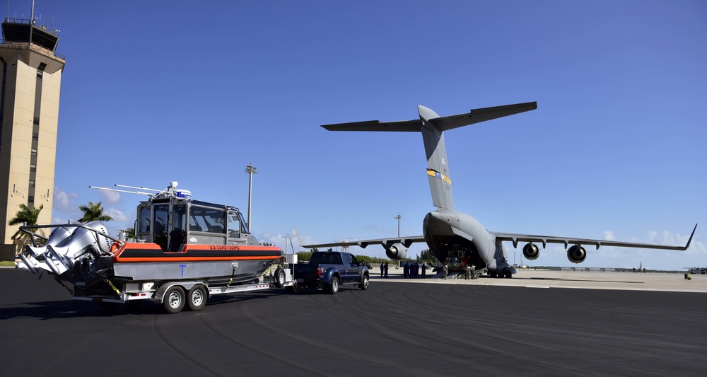 Coast Guard MSST Miami prepares to load a small boat onto an Air Force C-17