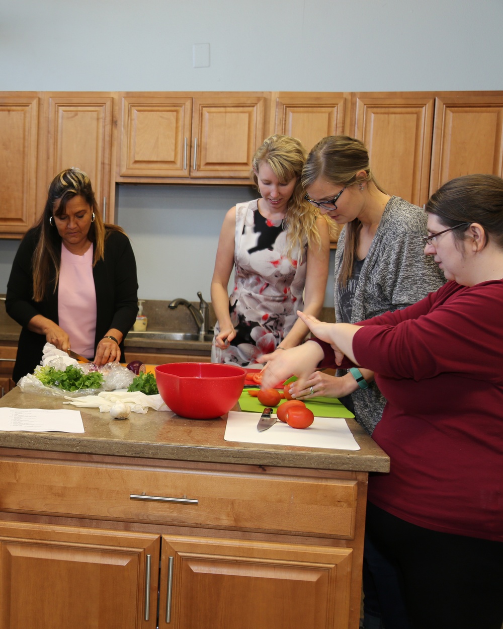 Ashley Ignatz, Marine Corps Family Team Building trainer, coaches military spouses during a cooperative salsa making class, as part of the LINKS for Spouses training held aboard Marine Corps Logistics Base Barstow, Calif., Feb. 9.