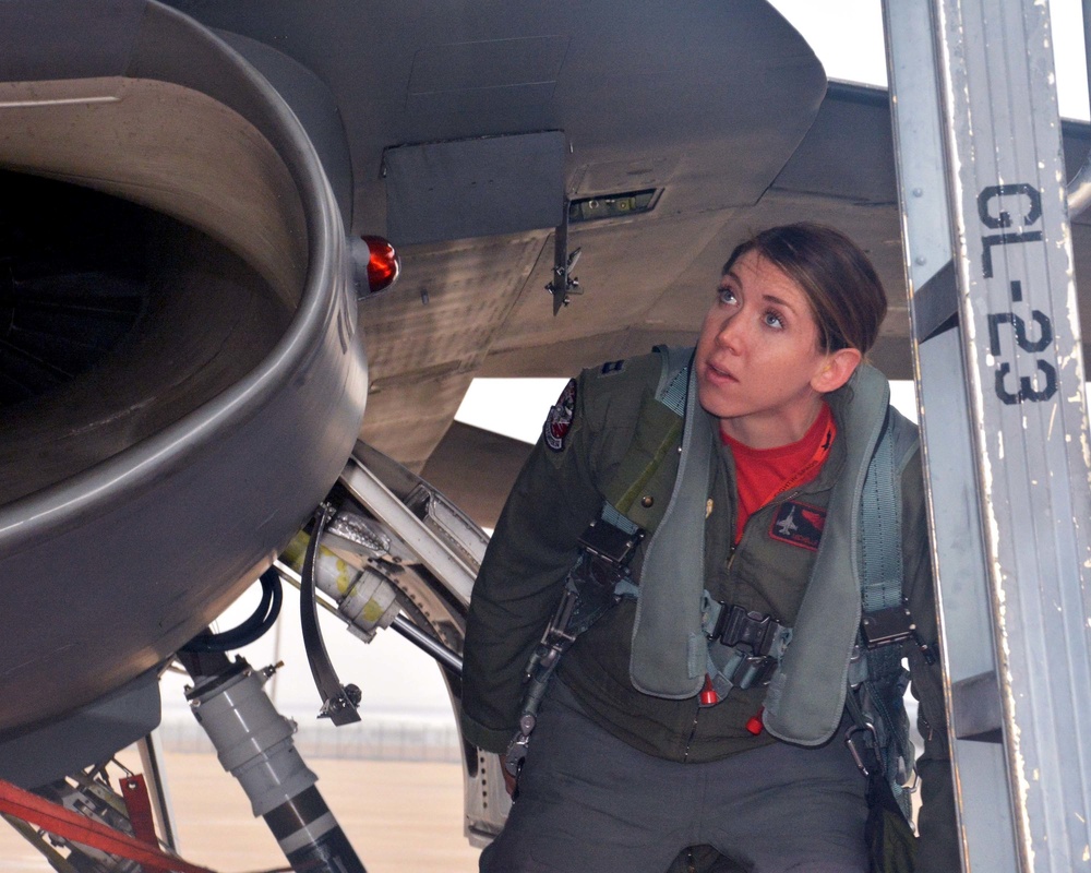 Pilot inspects her fighter jet