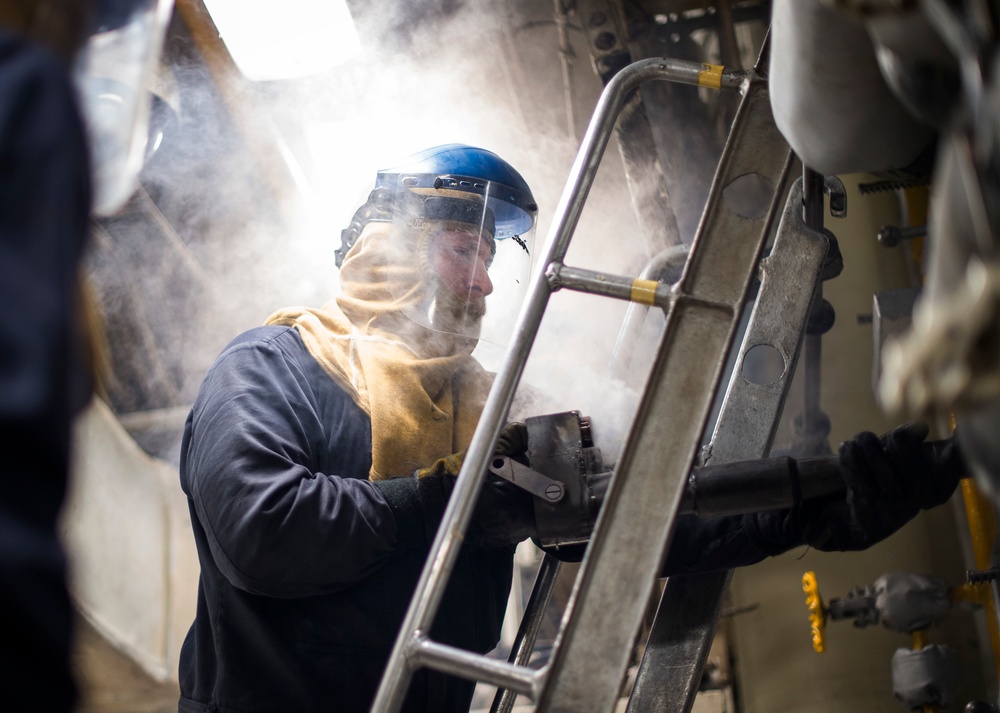 Engineering department boiler maintenance and nightly oil check aboard USS Bonhomme Richard