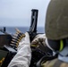 Green Bay Sailors fire an M240B machine gun off the ship