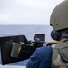 Green Bay Sailors fire an M240B machine gun off the ship