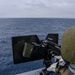 Green Bay Sailors fire an M240B machine gun off the ship