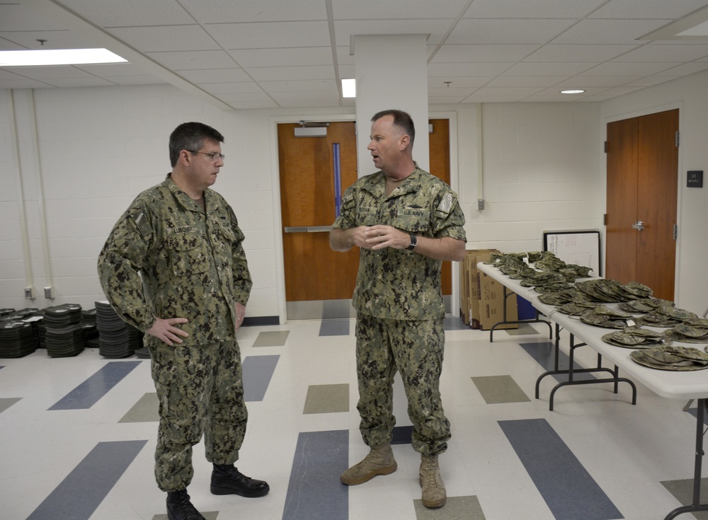 Rear Adm. Luscher Tours Uniform Fitting Facility at ECRC