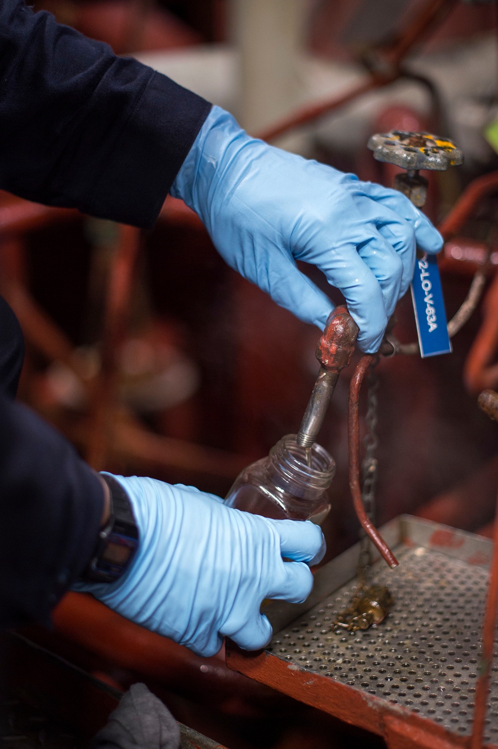 Engineering department boiler maintenance and nightly oil check aboard USS Bonhomme Richard