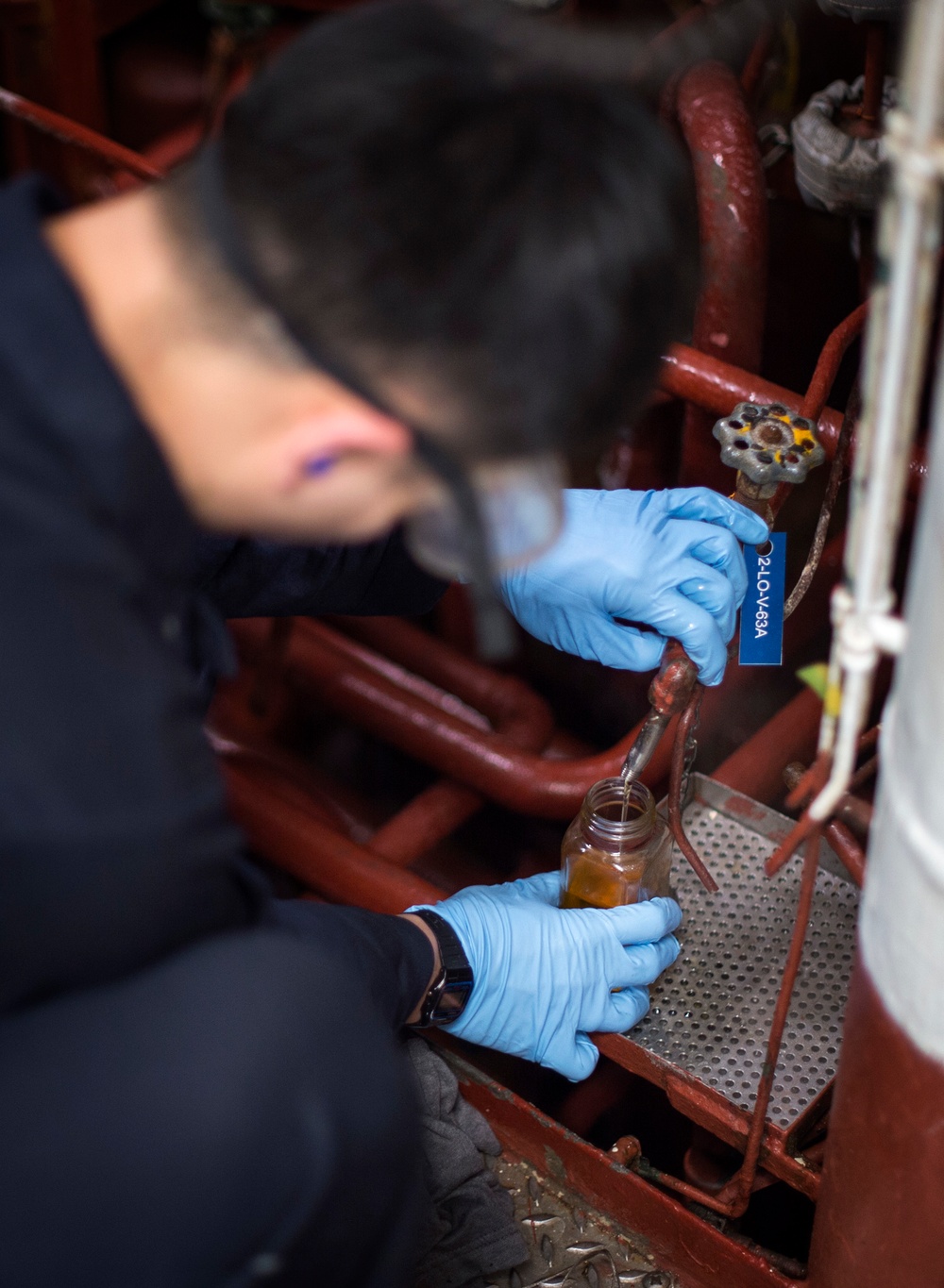 Engineering department boiler maintenance and nightly oil check aboard USS Bonhomme Richard