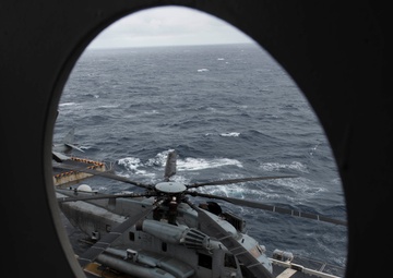 Marines assigned to the "Flying Tigers" Marine Tiltrotor Squadron (VMM) 262 (Reinforced) conduct maintenance checks on a CH-53E Super Stallion