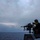 Green Bay Sailors fire an M240B machine gun off the ship