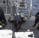 Fire Controlmen assigned to amphibious assault ship USS Bonhomme Richard (LHD 6) stow dummy rounds