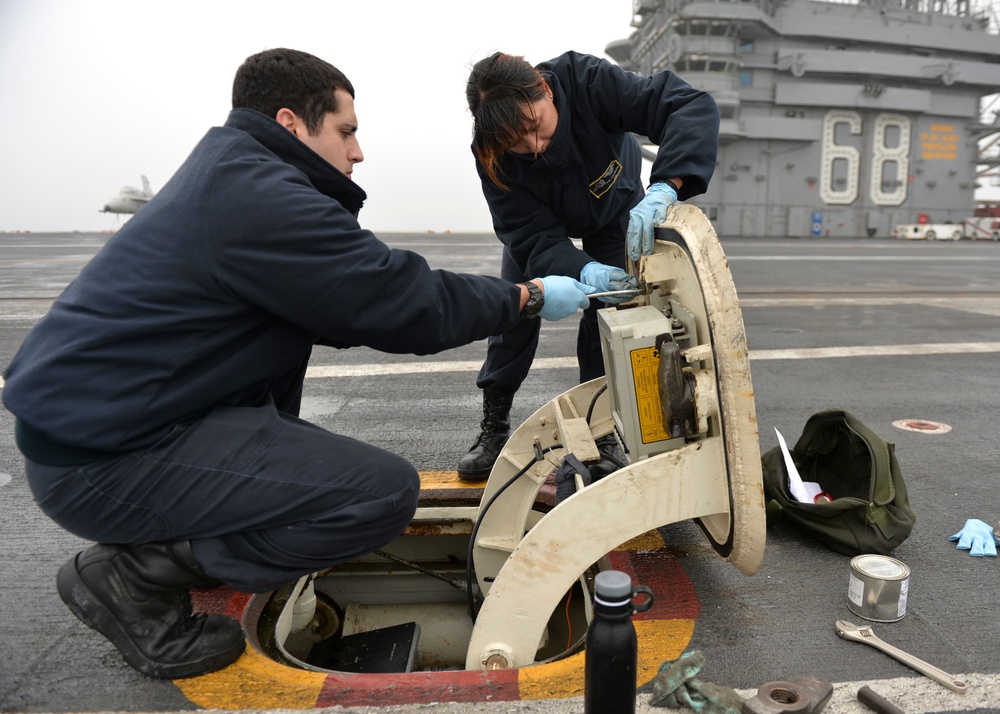 Sailors perform maintenance