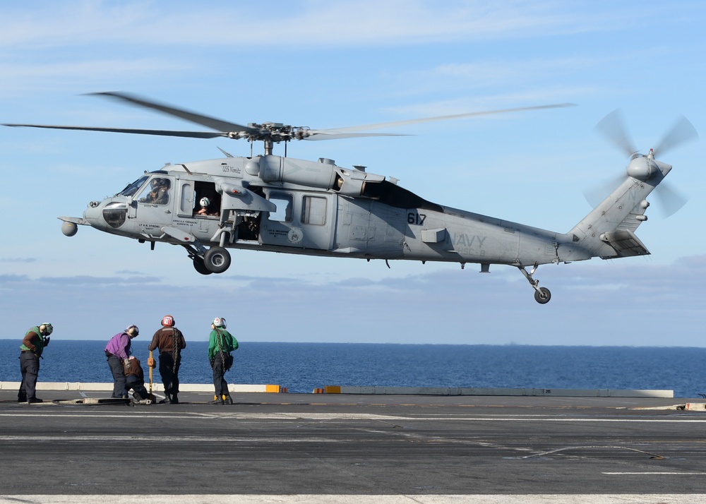 Helicopter prepares to lands on flight deck