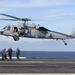 Helicopter prepares to lands on flight deck