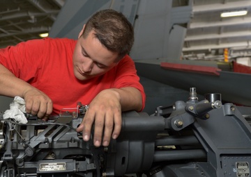 Sailor cleans machine gun
