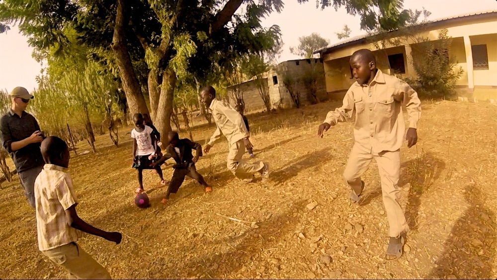 Soldier plays soccer at Cameroon orphanage