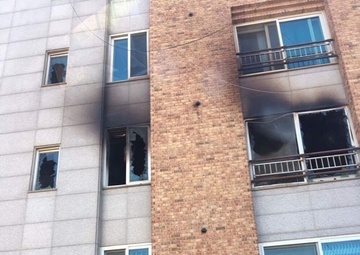 Soldier scales building to save family