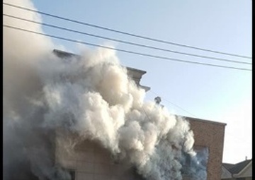 Soldier scales building to save family