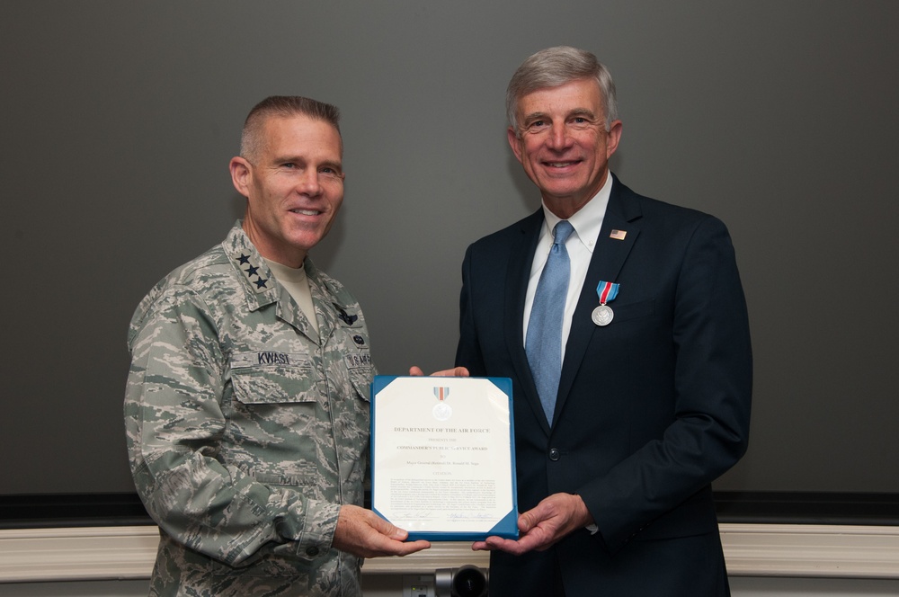 Commander's Public Service Award to Maj Gen (Retired) Ronald M. Sega