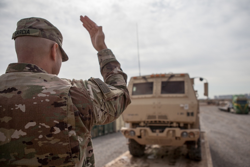 Soldiers load vehicles, HIMARS for transport