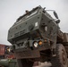 Soldiers load vehicles, HIMARS for transport