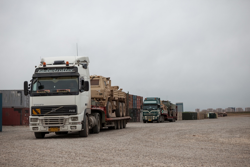 Soldiers load vehicles, HIMARS for transport