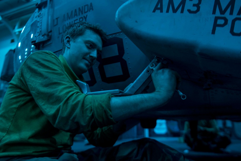 Navy Airman Conducts Maintenance on an MH-60S Sea Hawk