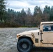 A high mobility multipurpose wheeled vehicle (HMMWV) sits parked in front of Sequalitchew Lake