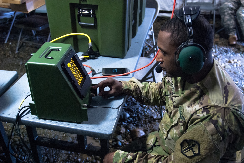 Sgt. Kenneth G. Elliott programs a Crew Access Unit (CAU) inside the 301st Maneuver Enhancement Brigade tactical command post
