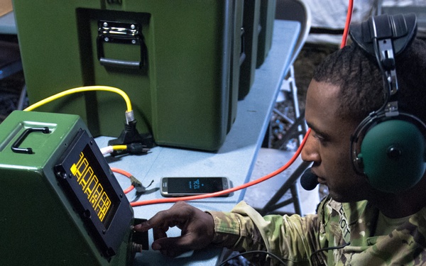 Sgt. Kenneth G. Elliott programs a Crew Access Unit (CAU) inside the 301st Maneuver Enhancement Brigade tactical command post