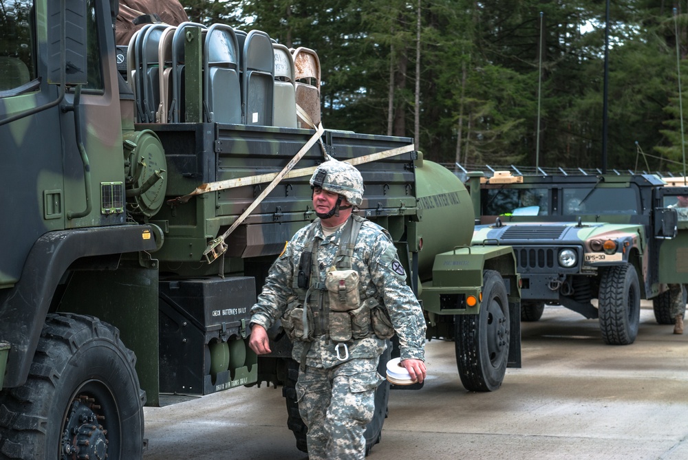 Sgt. Maj. Roy B. Smith inspects vehicles inside of the 301st Maneuver Enhancement Brigade motor pool