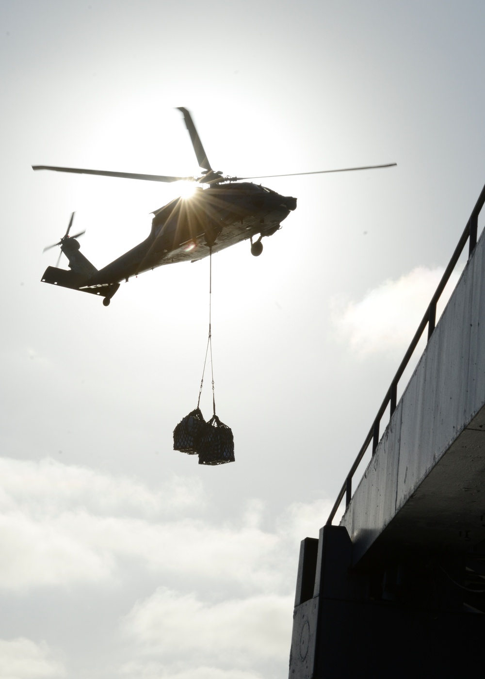 Helicopter conducts vertical replenishment-at-sea