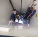 Gunner’s Mate 3rd Class Zachary Larkin and  and Fire Controlman 3rd Class Jose Gonzalez Paint the Interior of an Ordnance Lift Aboard USS Michael Murphy