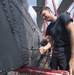 Aviation Machinist’s Mate 3rd Class Leo Stapleton Loosens a Bolt on the Tail Pylon of an MH-60R Helicopter Aboard USS Michael Murphy