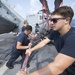 Aviation Electrician’s  Mate 3rd Class Dominick Strona Helps Fold the Tail Pylon of an MH-60R Helicopter Aboard USS Michael Murphy (DDG 112)