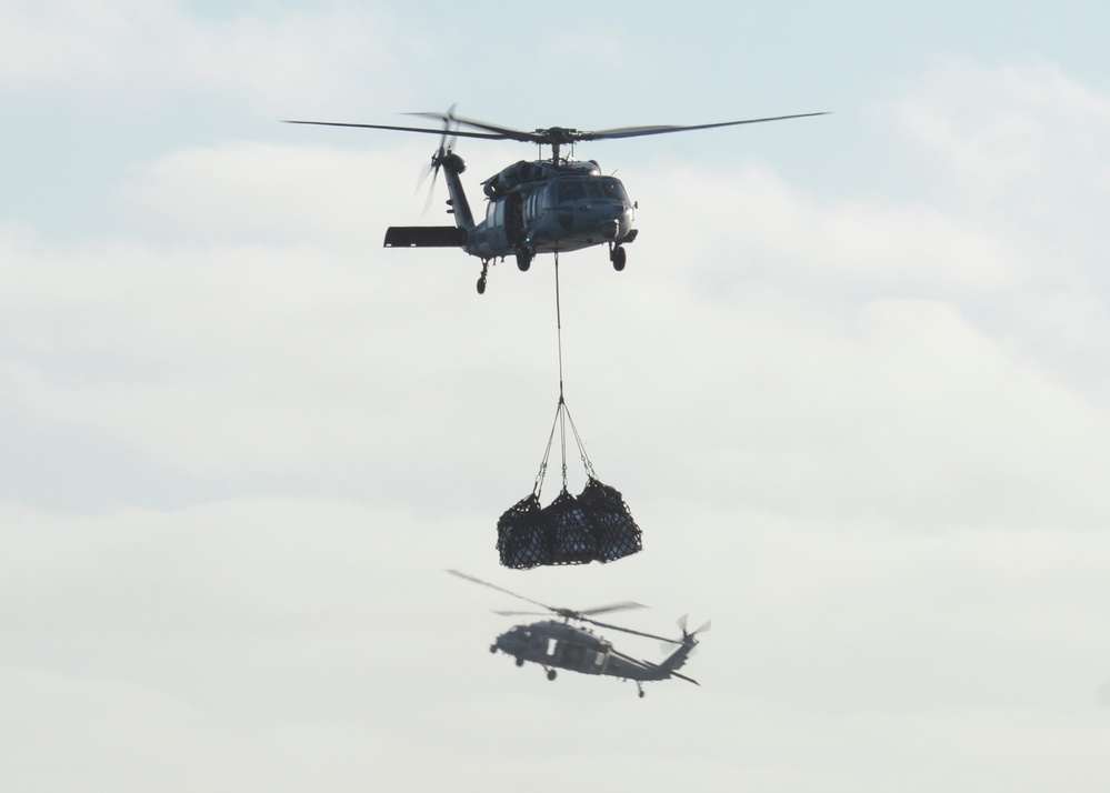Helicopters conduct vertical replenishment-at-sea