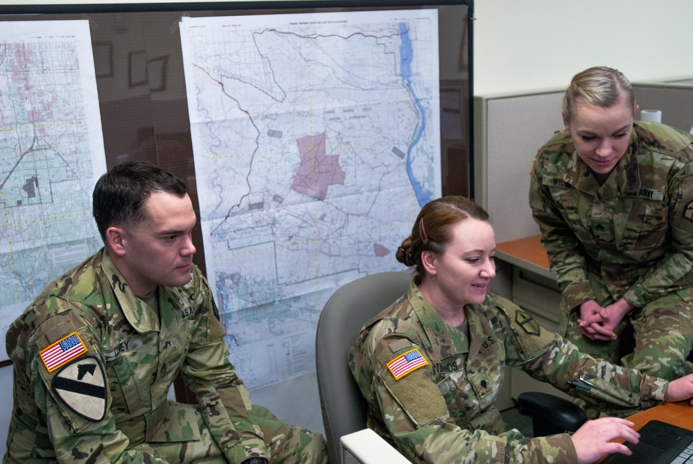 301st Maneuver Enhancement Brigade geospatial engineers work together to produce a Combined Obstacle Overlay