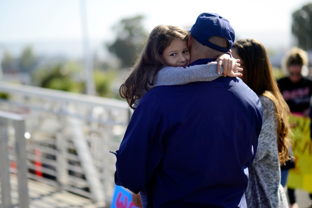 A father embraces his daughter