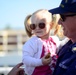 A father puts sunglasses on his daughter