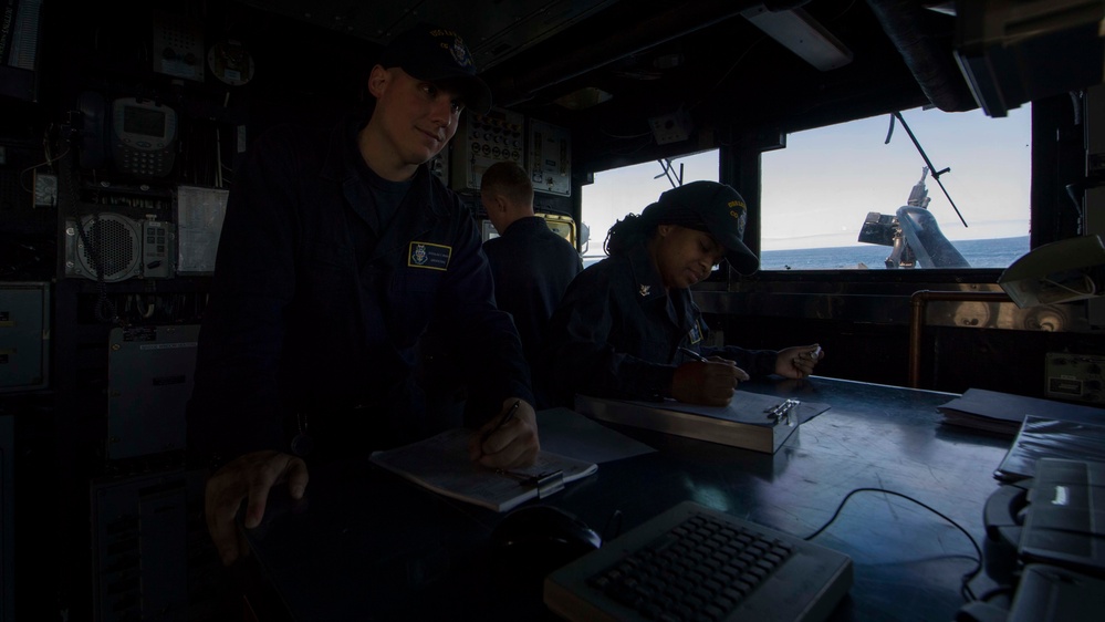 Quartermaster Seaman Douglas Mahan and Quartermaster 2nd Class Brittney Hines Record the Ship’s Position