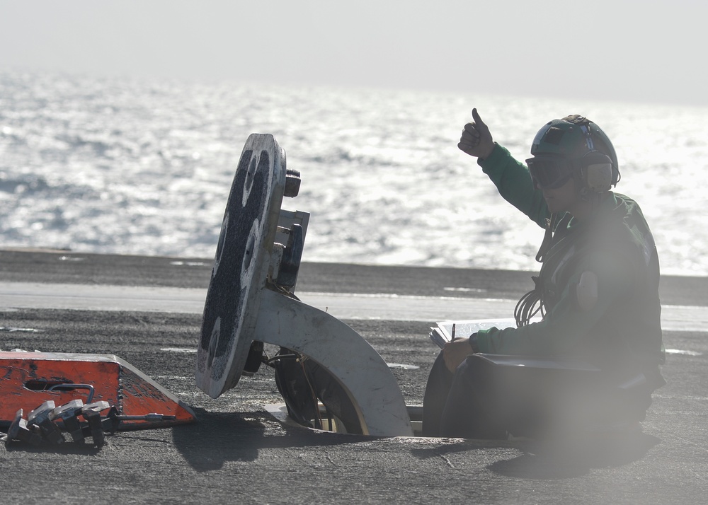 Sailor signals clear to launch an aircraft