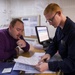 Personnel Specialist Seaman Cody Burkhart assists Aviation Boatswain’s Mate 3rd Class Jeremy Pollard with Paperwork On Board USS America