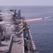 A rolling airframe missile (RAM), a surface-to-air intercept missile, launches from amphibious assault ship USS America (LHA 6)