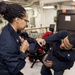 Aviation Electronics Technician 3rd Class Aaron Searcy (right) and Master-at-Arms 3rd Class Deja Otoki (left) perform take down techniques during self-defense training
