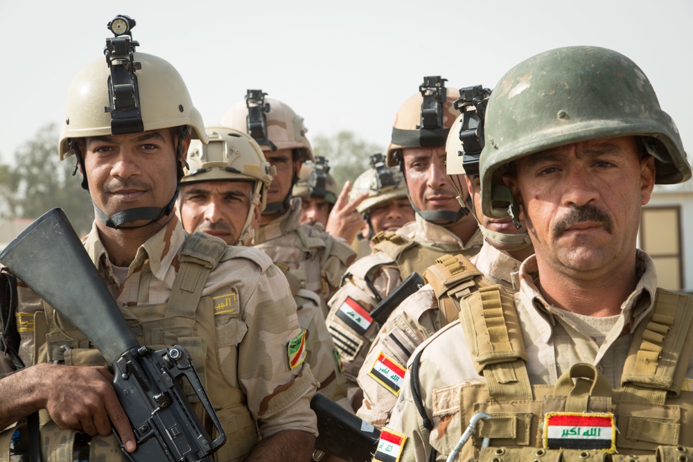 Iraqi security forces group and zero their rifles