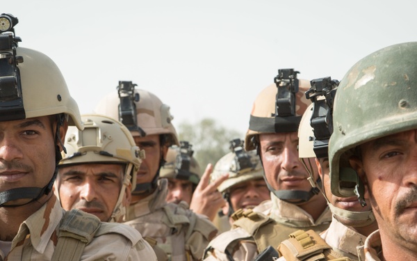 Iraqi security forces group and zero their rifles