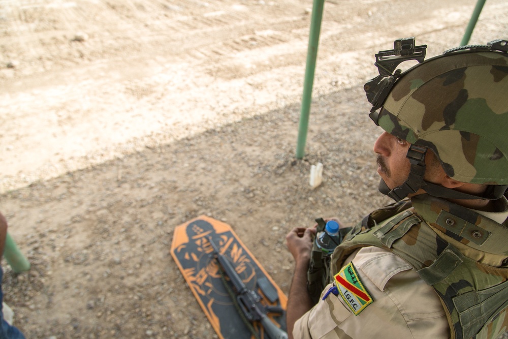 Iraqi security forces group and zero their rifles