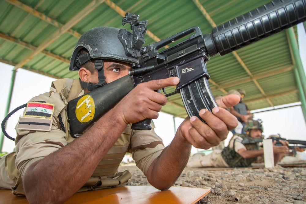 Iraqi security forces group and zero their rifles