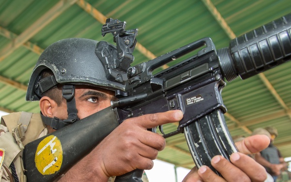 Iraqi security forces group and zero their rifles