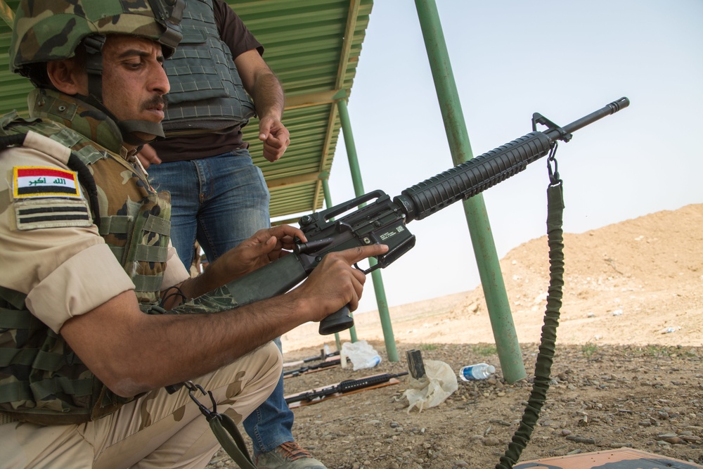 Iraqi security forces group and zero their rifles