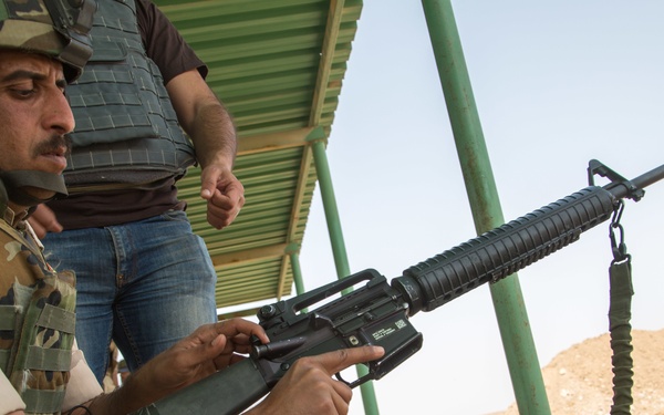 Iraqi security forces group and zero their rifles