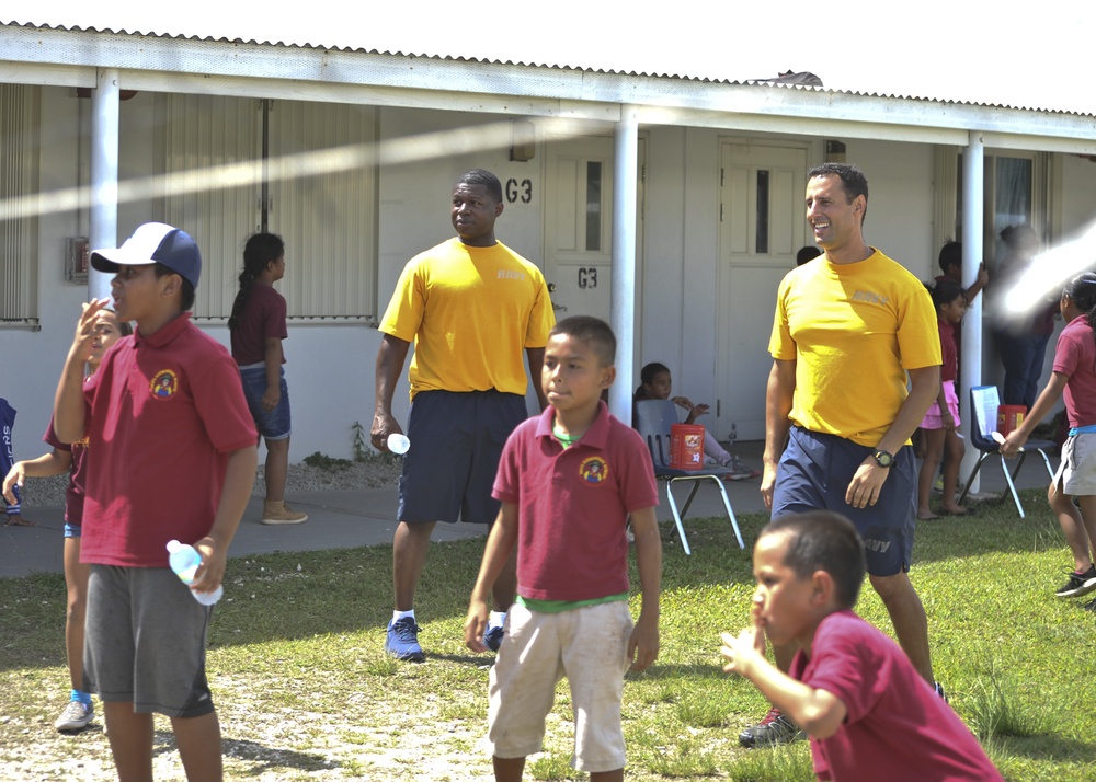 Two ESL Sailors join in a volleyball game at a local Guam school